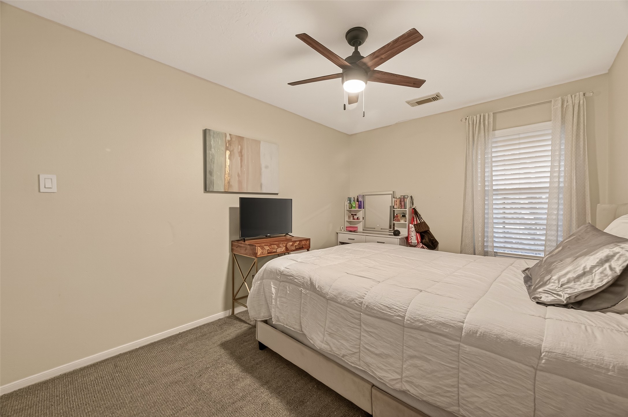 12206 Paddock Way Houston, TX 77065 - Photo 26 of 44 a bedroom with a large bed and a tv