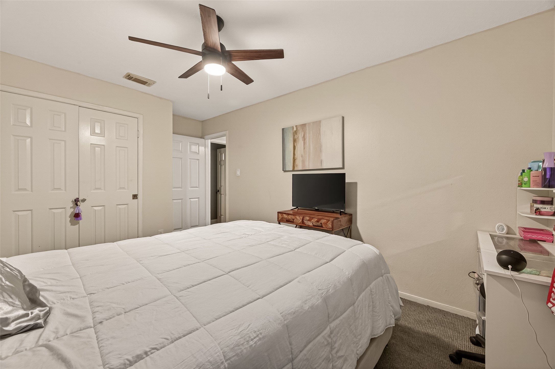 12206 Paddock Way Houston, TX 77065 - Photo 27 of 44 a bedroom with a bed and a flat screen tv