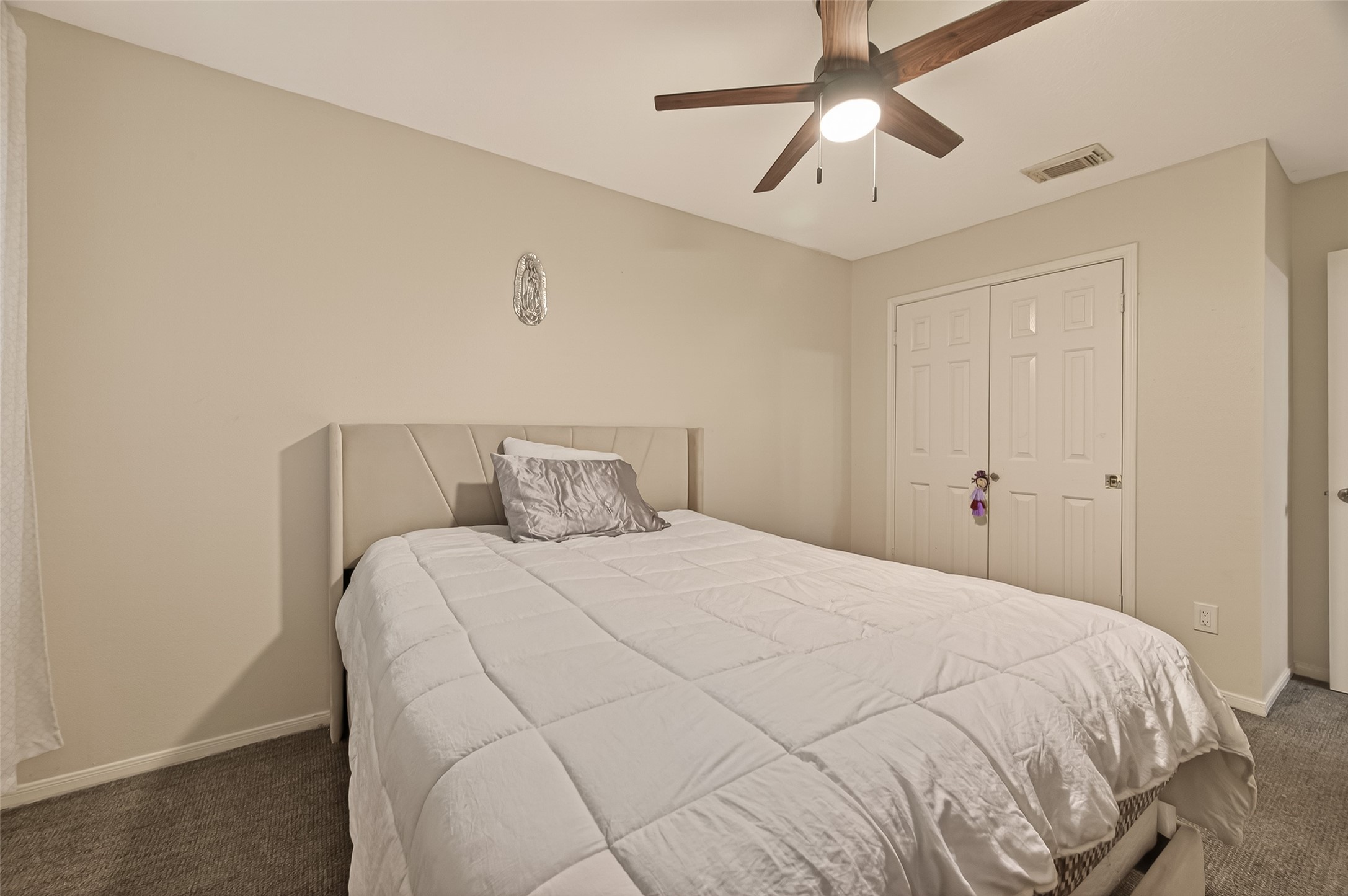 12206 Paddock Way Houston, TX 77065 - Photo 28 of 44 a bedroom with a bed and a chandelier