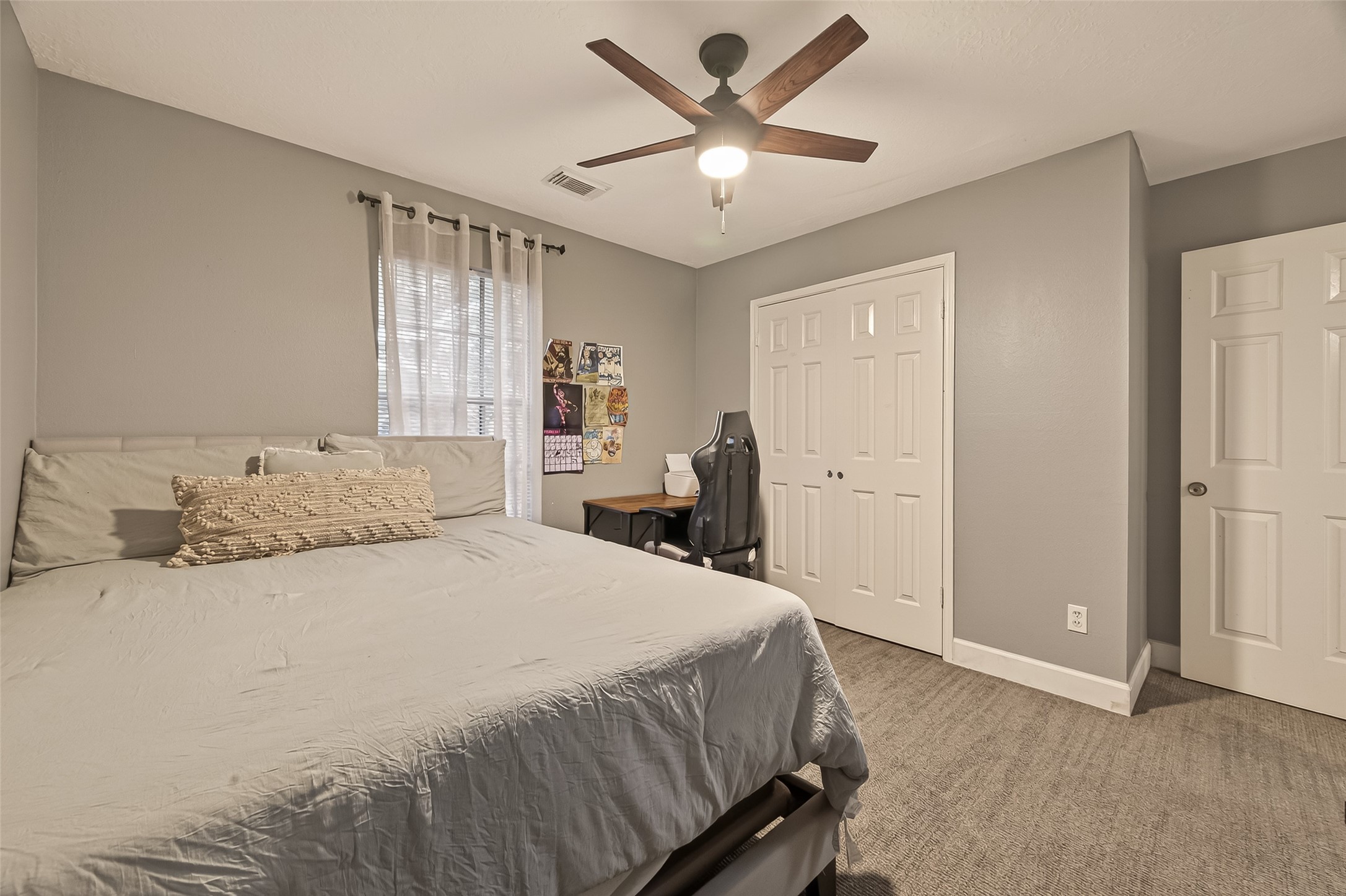 12206 Paddock Way Houston, TX 77065 - Photo 30 of 44 a bedroom with a large bed and a chandelier