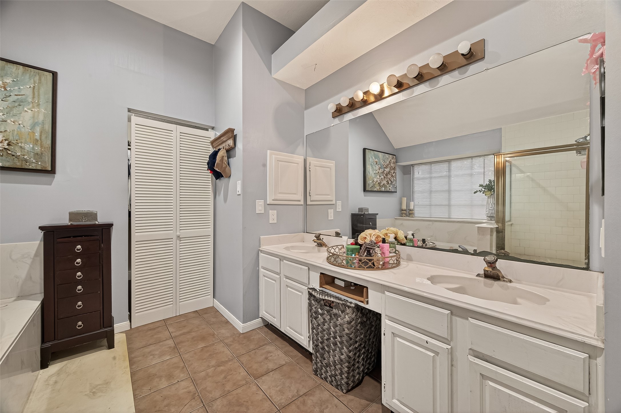12206 Paddock Way Houston, TX 77065 - Photo 36 of 44 a bathroom with a sink double vanity and a shower