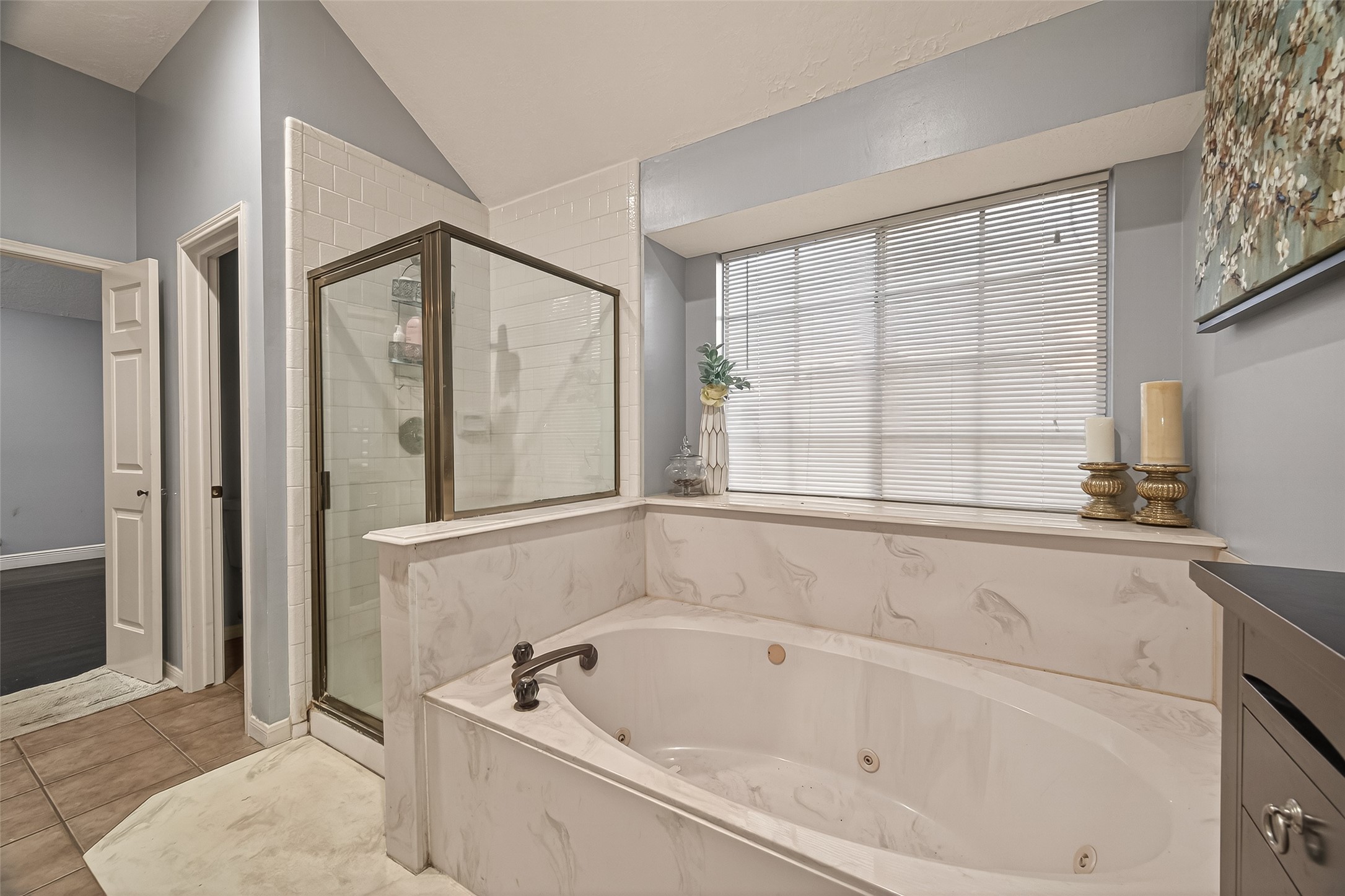 12206 Paddock Way Houston, TX 77065 - Photo 38 of 44 a bathroom with a bathtub and a shower