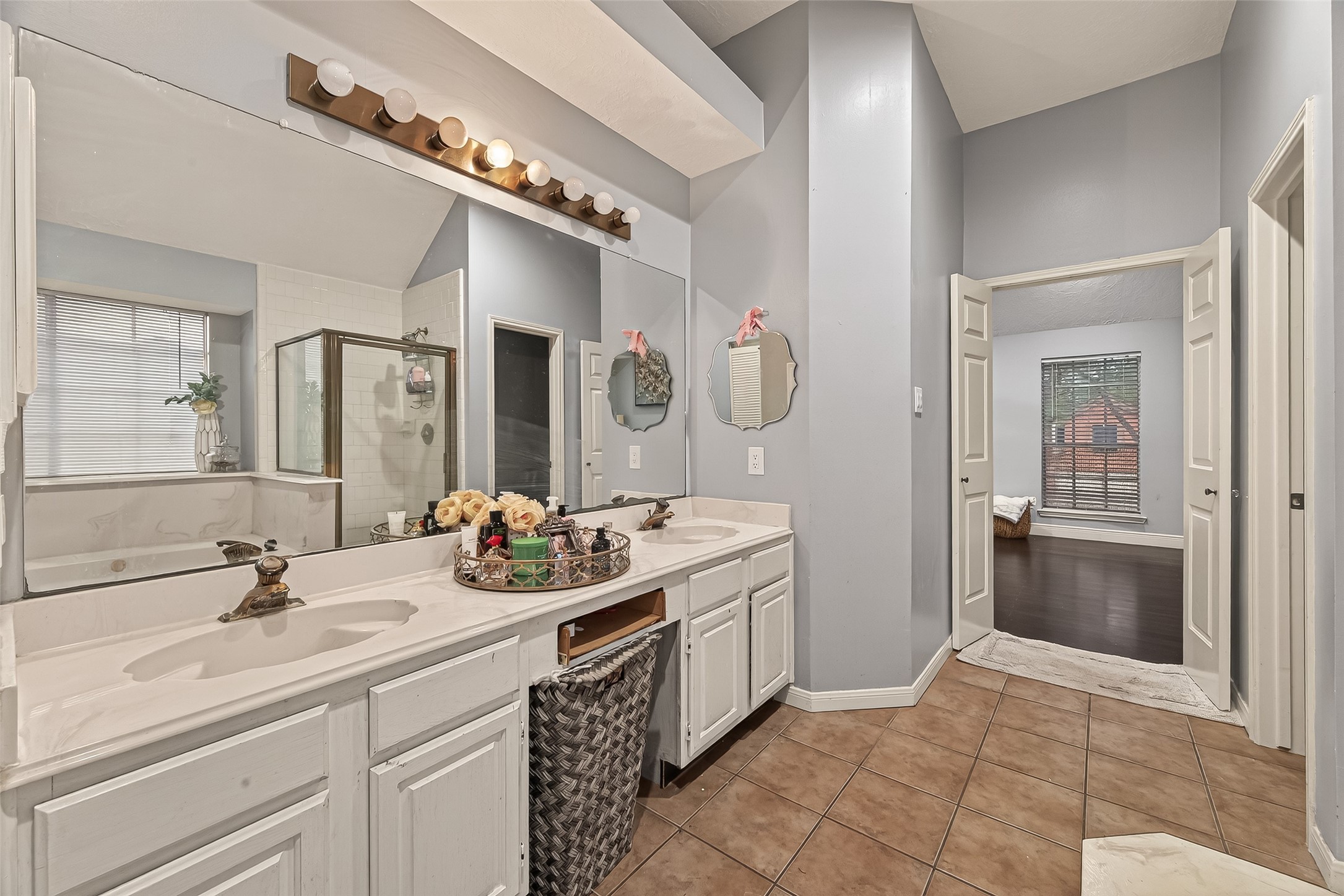 12206 Paddock Way Houston, TX 77065 - Photo 39 of 44 a bathroom with a sink and a mirror