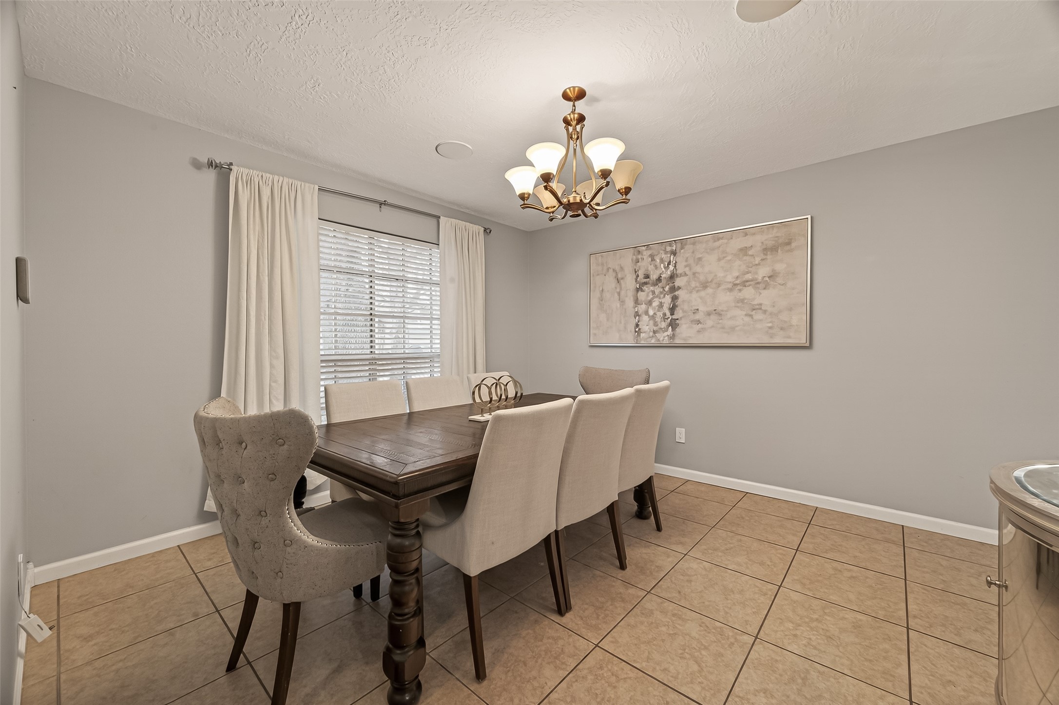 12206 Paddock Way Houston, TX 77065 - Photo 5 of 44 a view of a dining room with furniture and chandelier