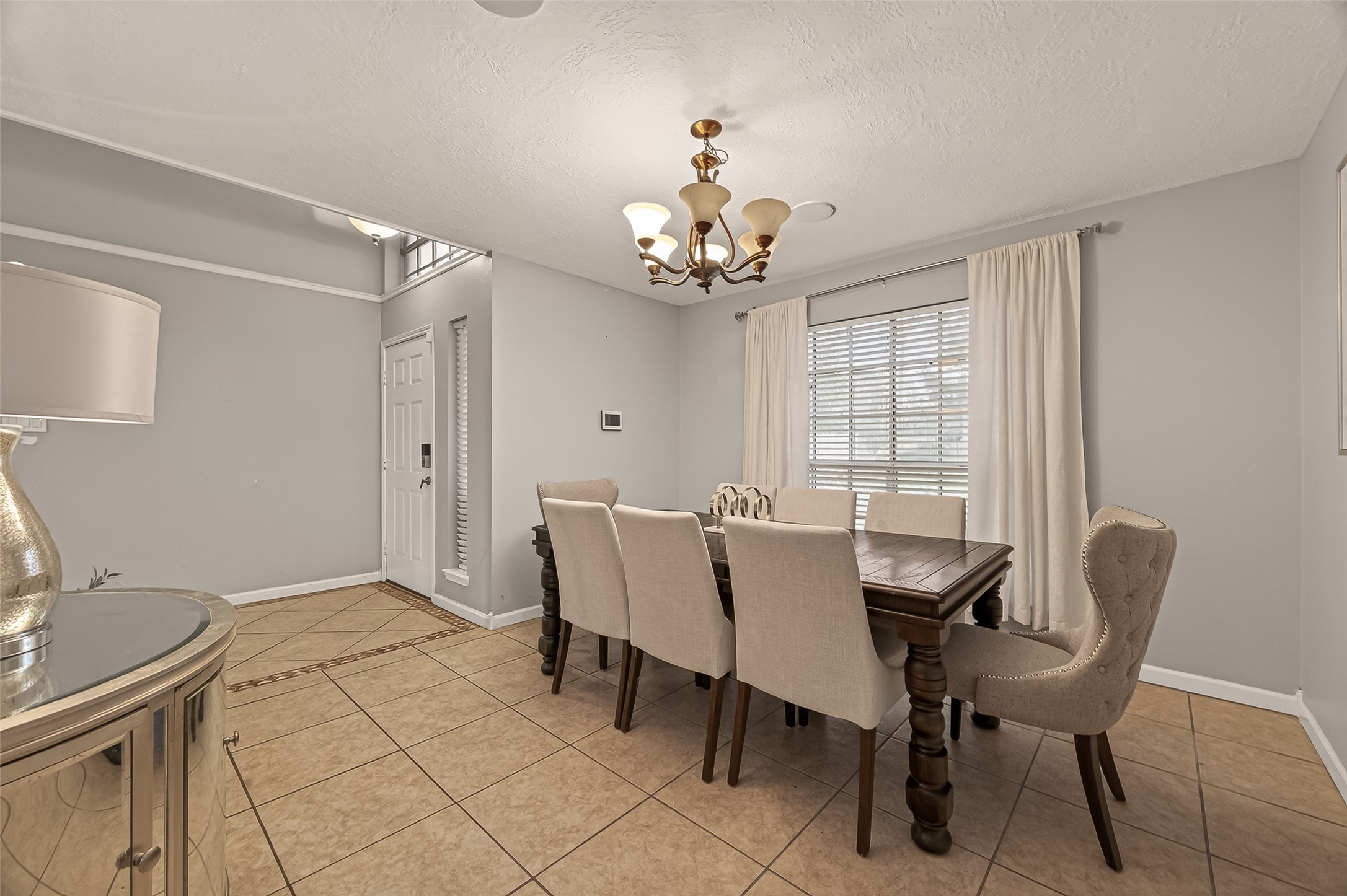 12206 Paddock Way Houston, TX 77065 - Photo 6 of 44 a view of a dining room with furniture and chandelier