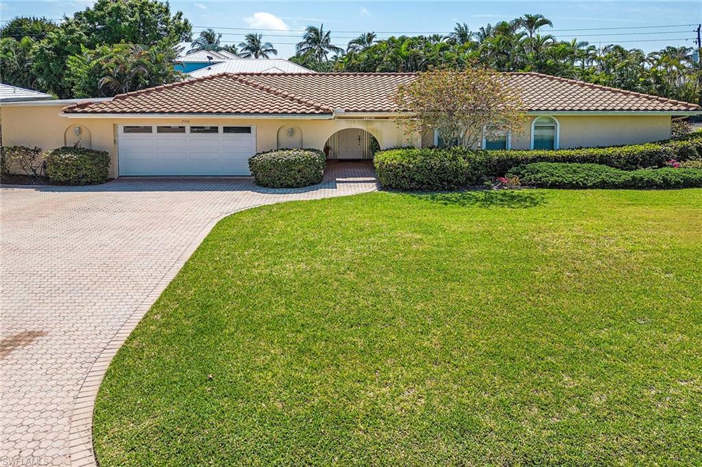 Undisclosed Address Naples, FL 34103 - Photo 6 of 6 a view of front of house with a yard