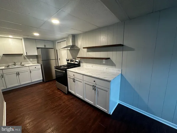 a kitchen with a sink cabinets and window
