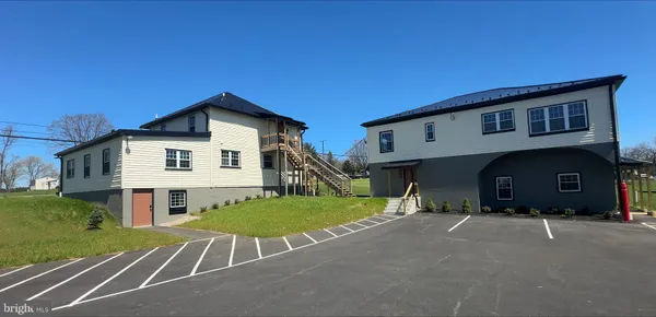 a view of a house next to a yard
