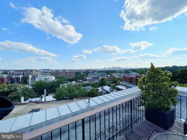 a view of a tall building next to a road