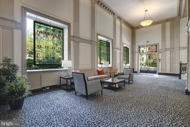 a street view with tall buildings and cars parked on the roadside