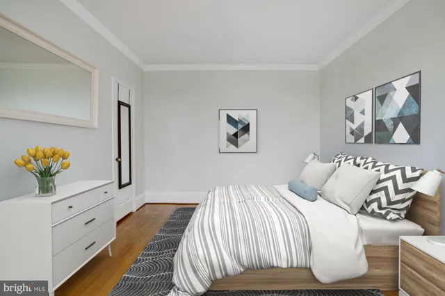 a bedroom with a bed and painting on the wall