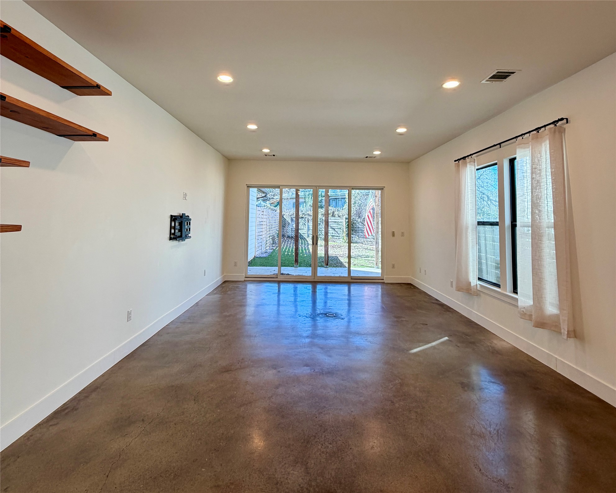 1515 Hether Street, Unit B Austin, TX 78704 - Photo 6 of 30 Natural light floods this living area through generous windows and glass doors, offering direct outdoor access.