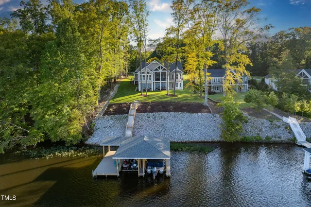 an aerial view of a house with swimming pool outdoor seating and yard