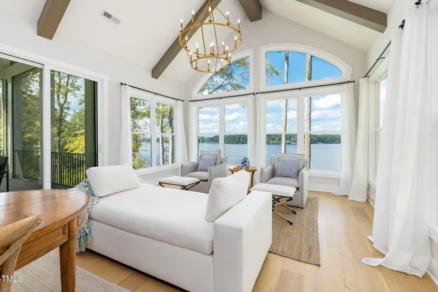 a living room with furniture a large window and a table