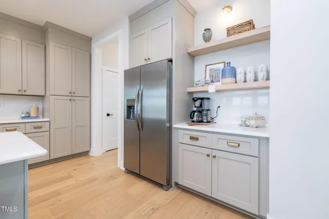 a spacious bathroom with a granite countertop sink and a mirror