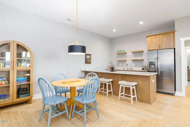 a terrace of a house with wooden floor and outdoor seating