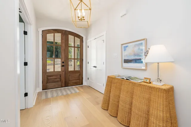 a living room with furniture a fireplace and a floor to ceiling window