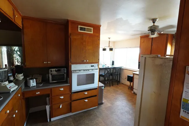a kitchen with a refrigerator and a stove