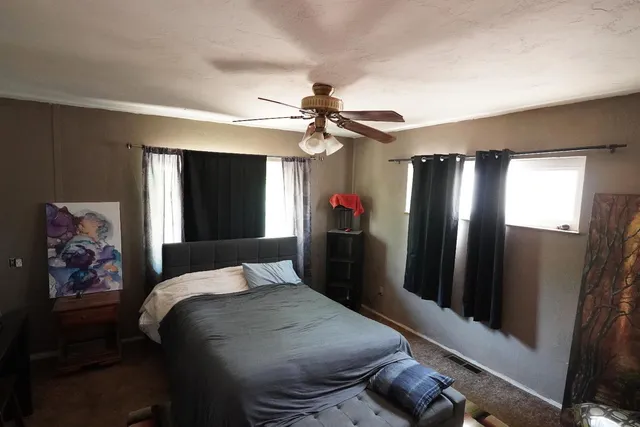 a bedroom with a bed dresser and a window