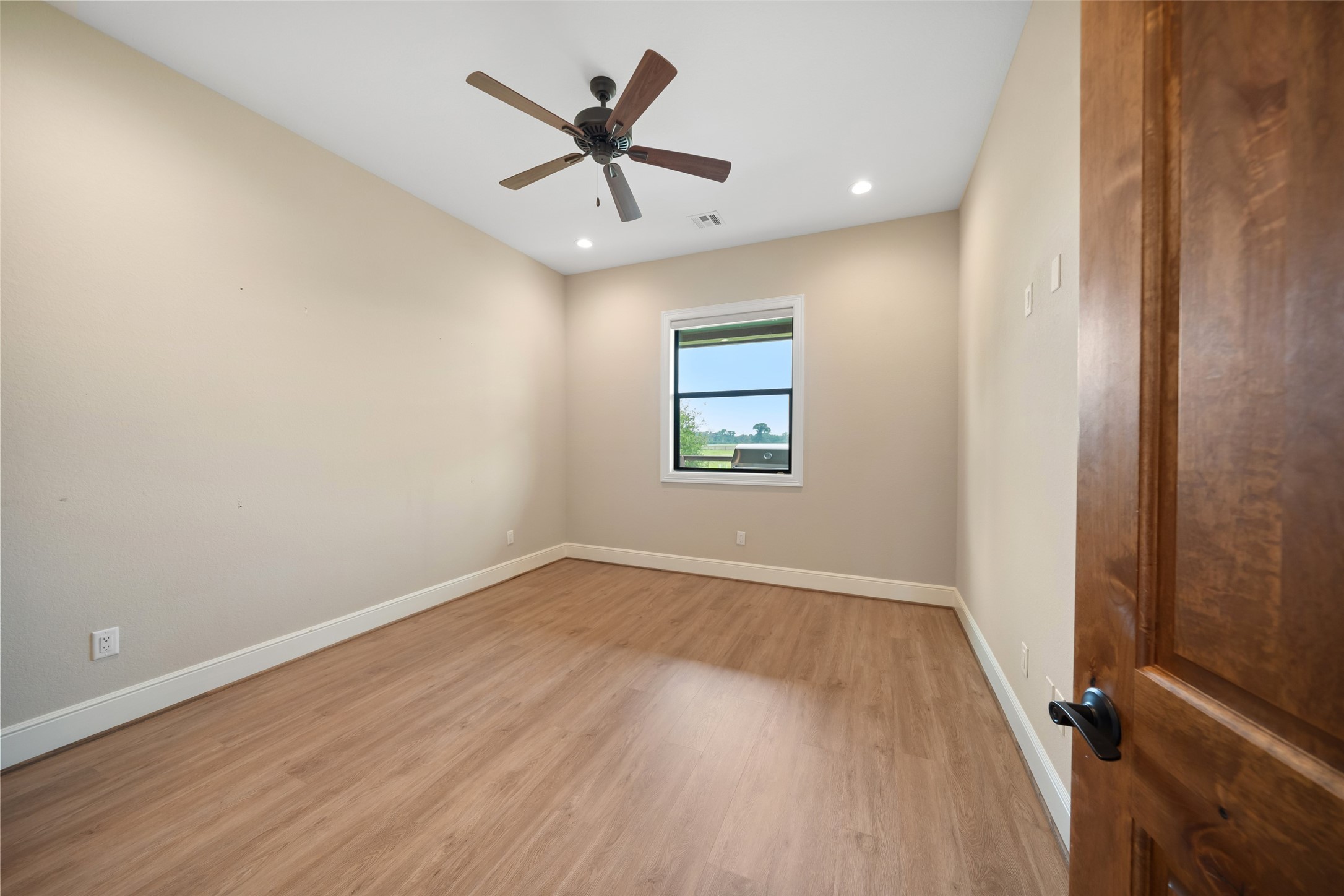 30163 High Spirit Ranch Road Hempstead, TX 77445 - Photo 30 of 49 an empty room with wooden floor and windows