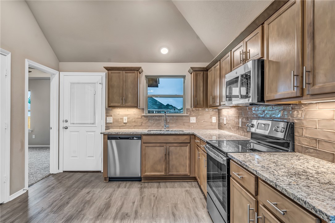 1218 High Street Navasota, TX 77868 - Photo 3 of 16 a kitchen with stainless steel appliances granite countertop wooden cabinets granite counter tops and a hard wood floors