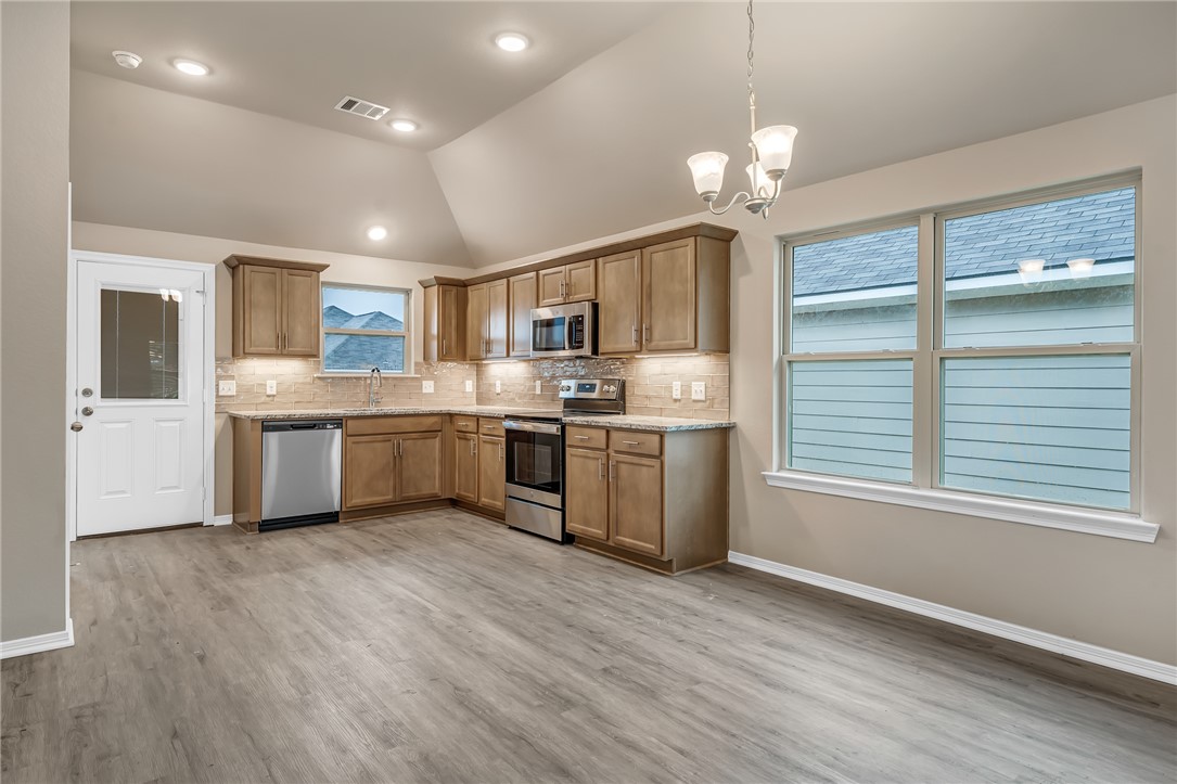 1218 High Street Navasota, TX 77868 - Photo 4 of 16 a kitchen with a stove a sink and a refrigerator