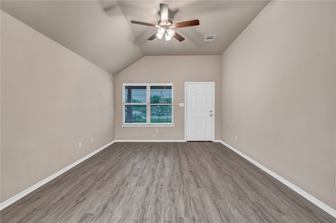 1218 High Street Navasota, TX 77868 - Photo 7 of 16 wooden floor in an empty room with a window