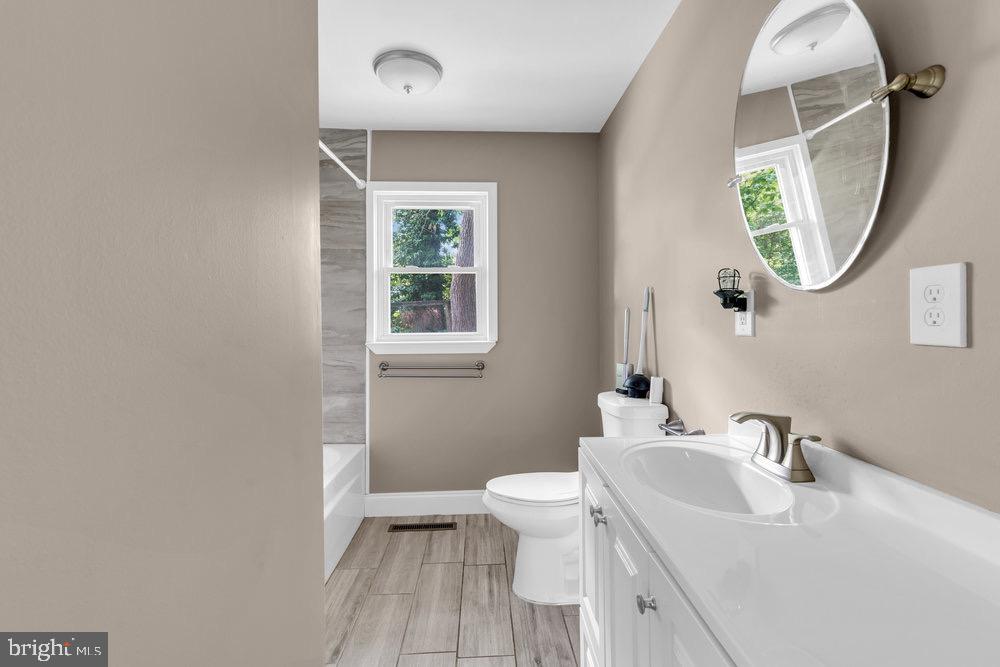 27 Litle Avenue Delran, NJ 08075 - Photo 14 of 20 a bathroom with a sink a toilet and a mirror