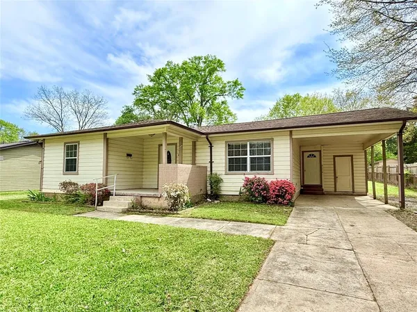 a front view of a house with yard and green space