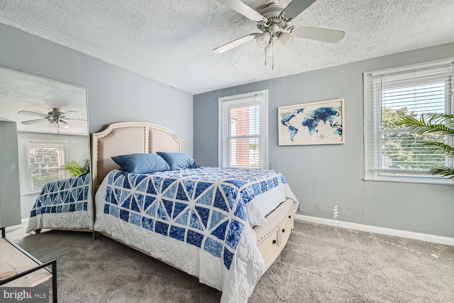 1215 West Old Cold Spring Lane Baltimore, MD 21211 - Photo 16 of 33 a spacious bedroom with a large bed and a chandelier