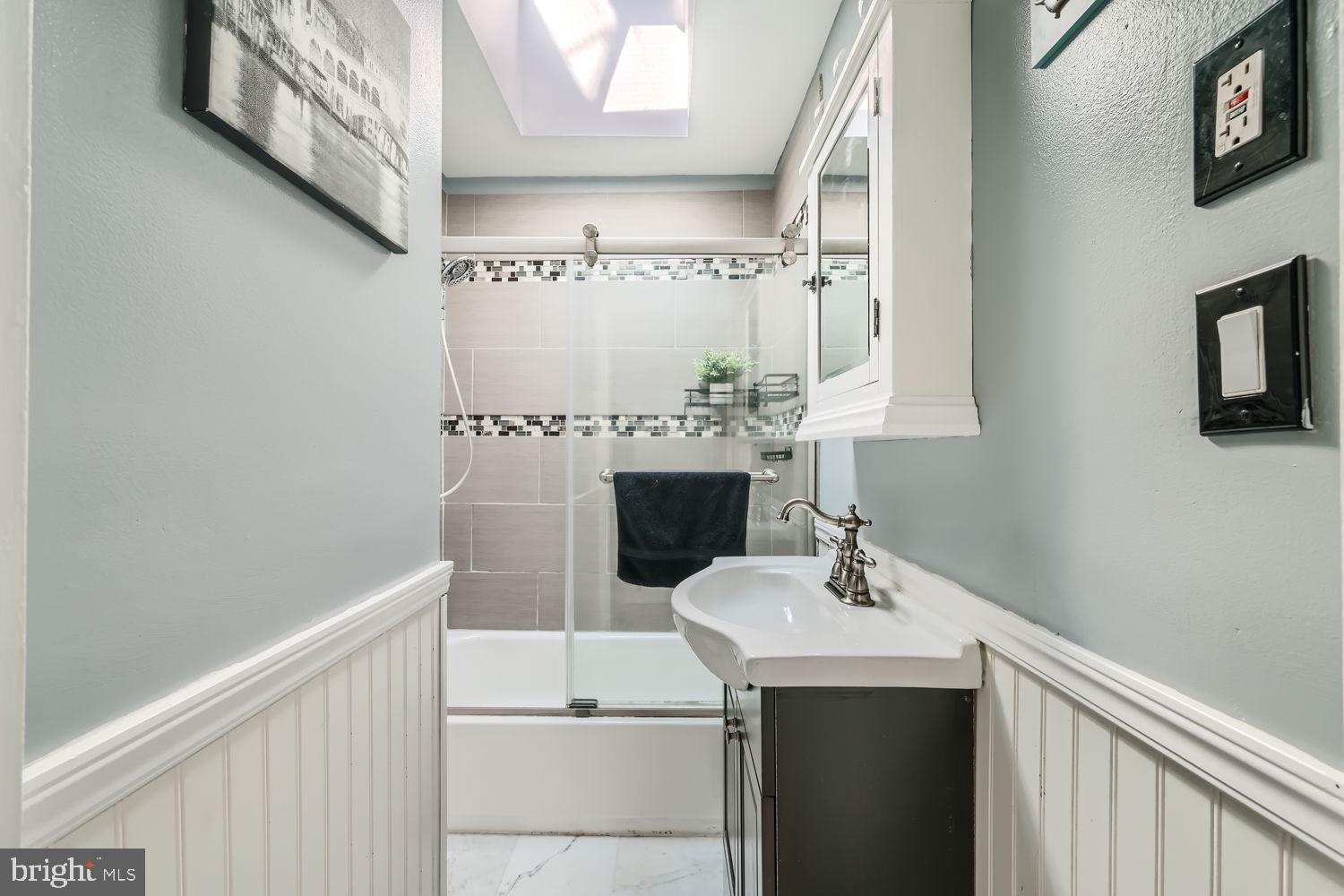1215 West Old Cold Spring Lane Baltimore, MD 21211 - Photo 17 of 33 a bathroom with a sink and a mirror