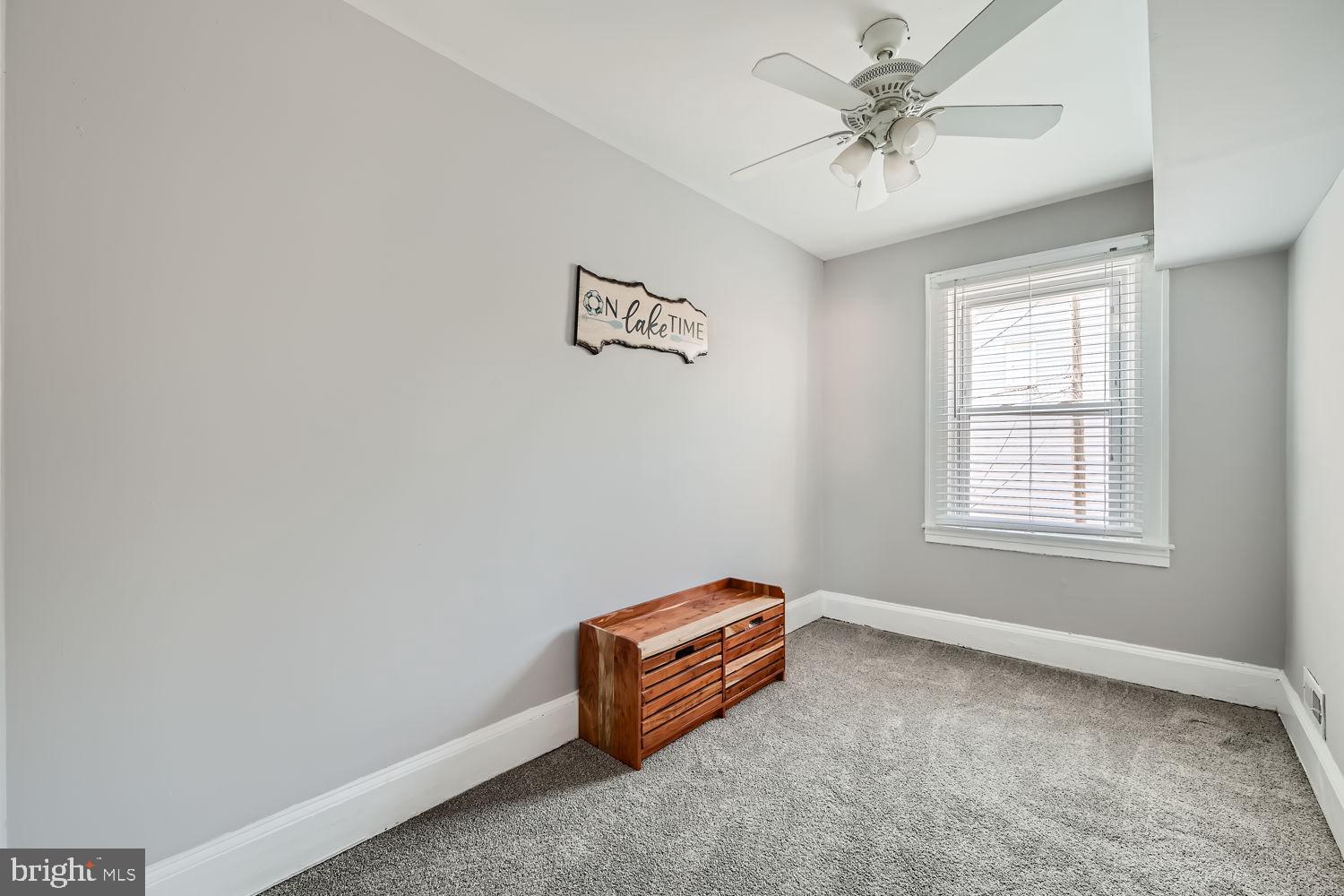 1215 West Old Cold Spring Lane Baltimore, MD 21211 - Photo 19 of 33 an empty room with windows and fan