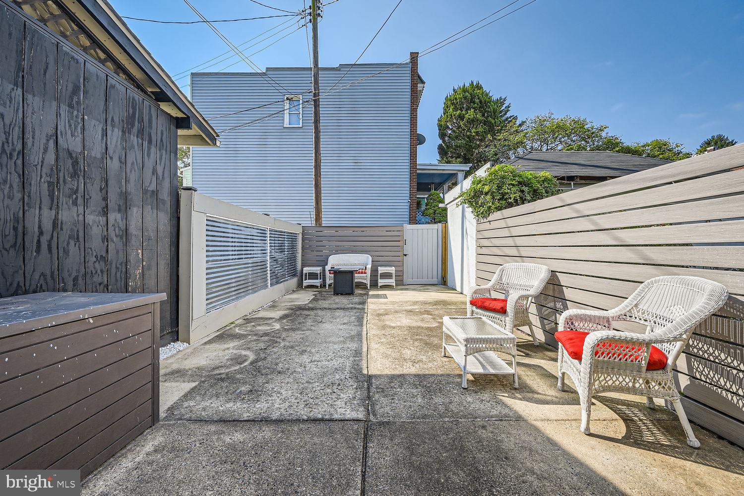 1215 West Old Cold Spring Lane Baltimore, MD 21211 - Photo 30 of 33 a view of a patio with table and chairs with wooden fence