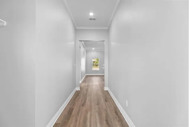 a view of a hallway with wooden floor