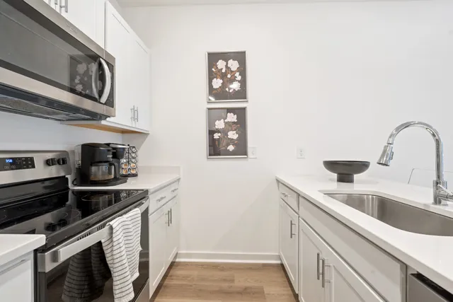 a kitchen with stainless steel appliances granite countertop a sink and cabinets