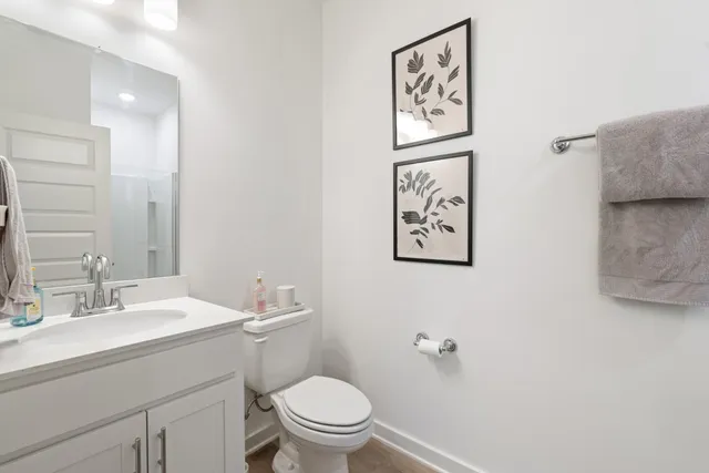 a bathroom with a toilet a sink and mirror