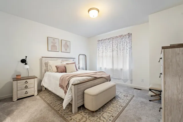 a bedroom with a bed and a couch