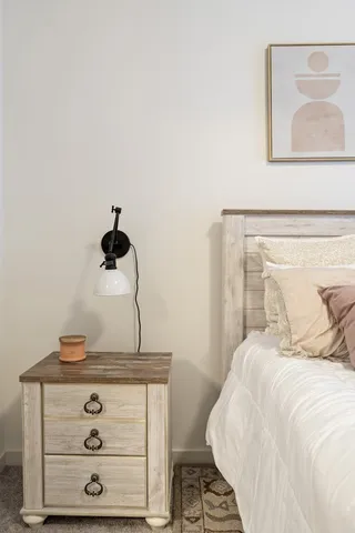 a bedroom with a bed and cabinets