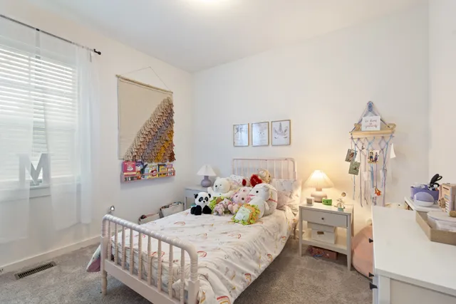 a bedroom with a bed and a table