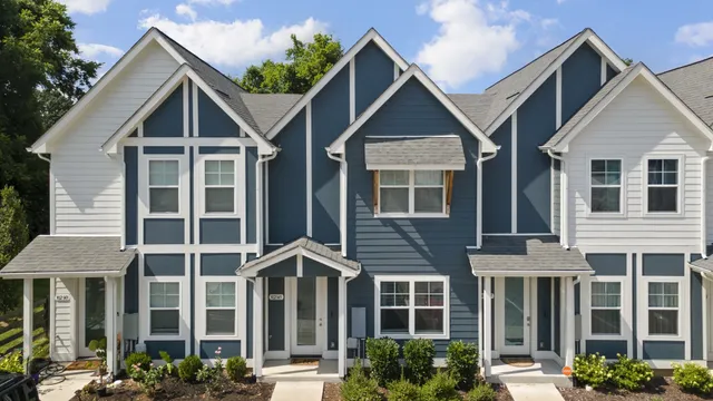 a view of a house with a yard and plants