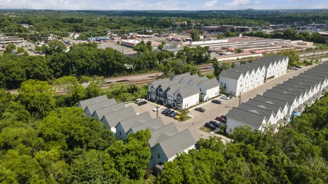 an aerial view of residential houses with outdoor space and river