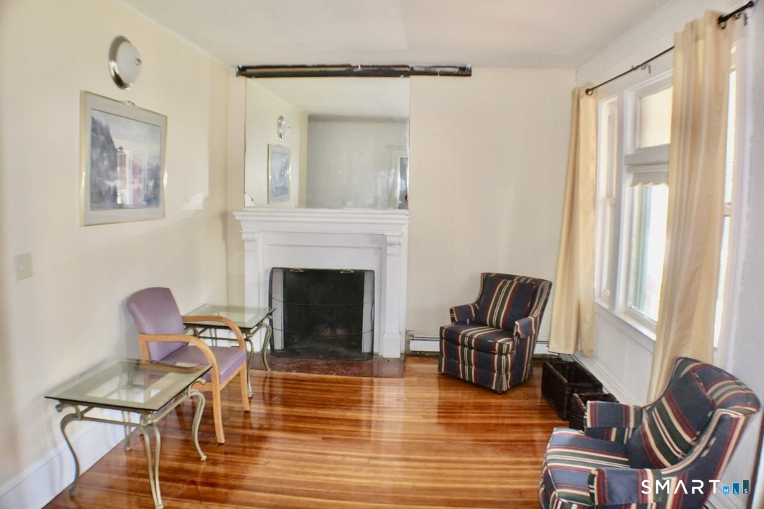 150 Whitney Street Hartford, CT 06105 - Photo 10 of 39 a living room with furniture and a fireplace