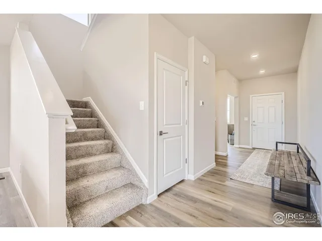 a view of an entryway with wooden floor
