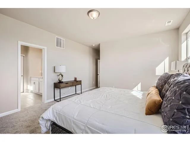 a bedroom with a bed and a table