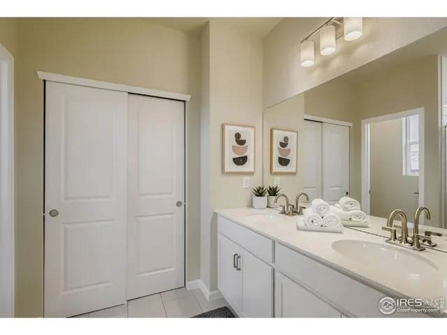 a bathroom with a double vanity sink and a mirror