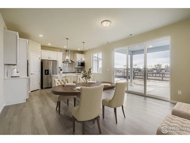 a view of a dining room and livingroom with furniture wooden floor