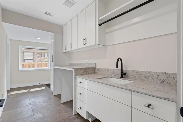 a kitchen with a sink and cabinets