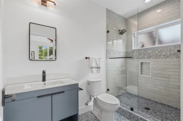 a bathroom with a toilet sink and shower