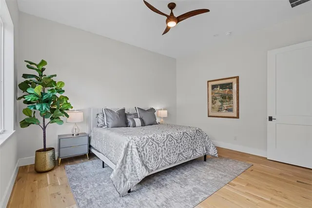 a bedroom with a bed and a potted plant