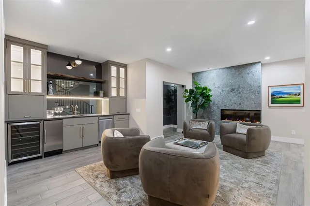 a living room with furniture and a kitchen